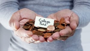 pennies in hands with college fund sign